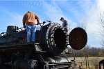 Attaching a cover for the hole where the smokestack was.